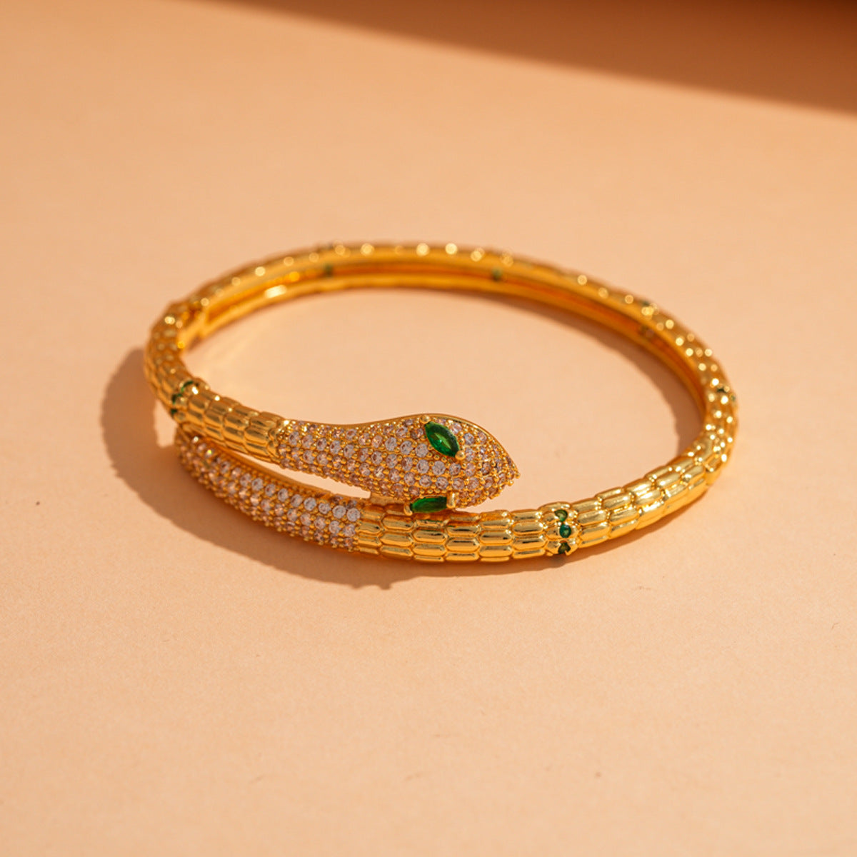 Jonila Dazzling Gold Serpent Bangle with Sparkling CZ & Emerald-Look Eyes